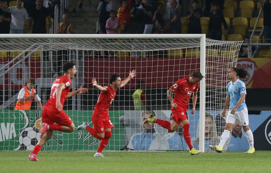 North Macedonia players celebrate after Ezgjan Alioski scores their first goal
