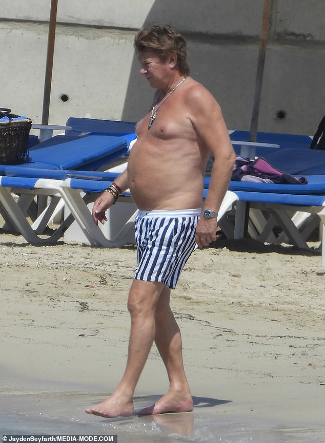Wilkins later stripped down to a pair of black-and-white striped boardies for a swim