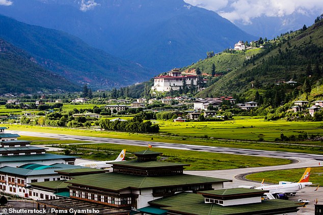Paro Airport , in Bhutan, is completely surrounded by the Himalayas and, when landing, planes have to dive through narrow valleys with no radar