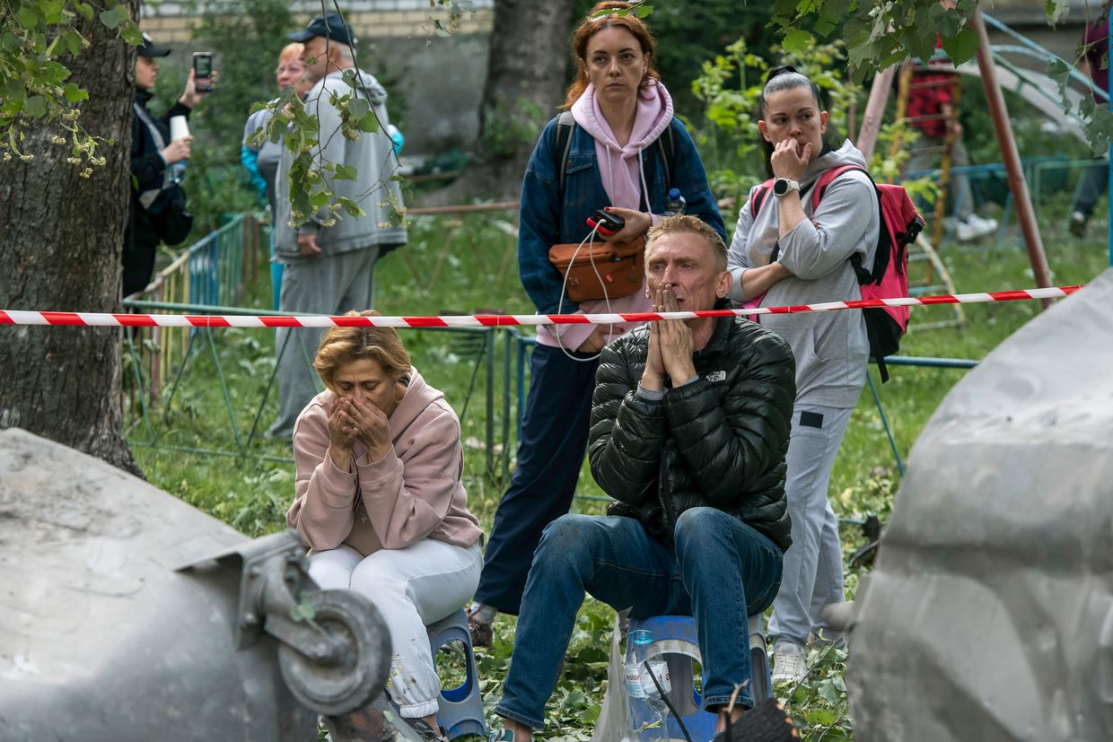 Family members of those still missing under the debris gather at the site of a residential building hit by a Russian ballistic missile in Kyiv, Ukraine, on June 17, 2025. 