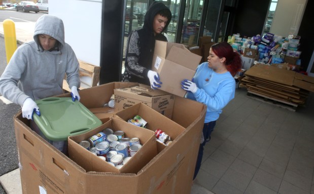 Keystone Job Corps members Emanuel Diaz, Jayden Mobley and Yesenia Mercado pack hurricane relief donate items into large shipping boxes at Blaise Alexander Mazda of Greater Hazleton to be shipped to aid hurricane victims on Thursday Oct. 24, 2024.(John Haeger / Staff Photographer)