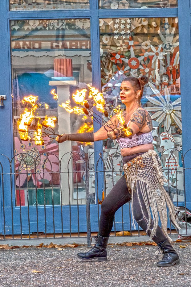 Grace Grimes handles three torches of fire performing with Humboldt...