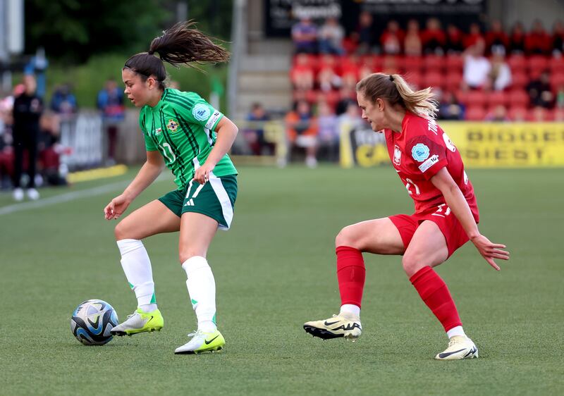 Northern Ireland’s Joely Andrews shadowed by Poland’s Paulina Tomasiak during Friday night's Women's Nations League game at Seaview, Belfast.