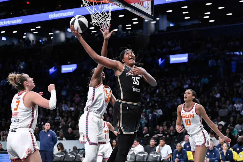 New York Liberty center Jonquel Jones shoots the ball while being defended by Connecticut Sun center Tina Charles.John Jones-Imagn Images