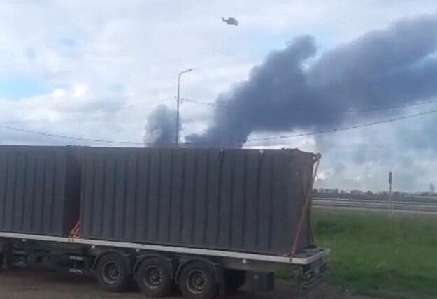 A drone lifts  off from a container that Ukrainian authorities said had been loaded onto a truck and driven to the  perimeter of an airbase inside Russia, as smoke rises in the background, in Mal'ta,  Irkutsk Region, Russia,  in a still image obtained from social media video posted on June 1,  2025. / Credit: Social Media/via REUTERS