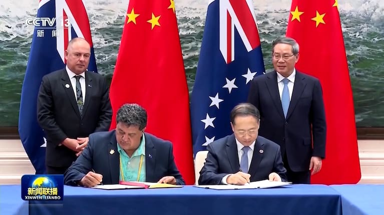 An agreement between Cook Islands and China is signed, in a video snapshot supplied by Chinese state broadcaster CCTV.