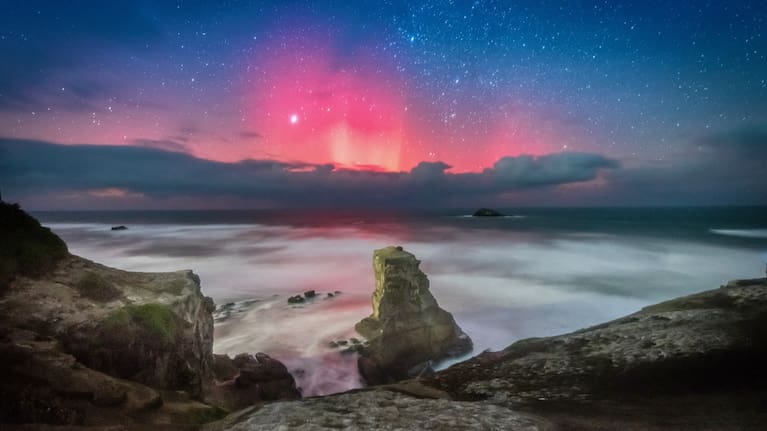 Aurora over Auckland Muriwai Beach.