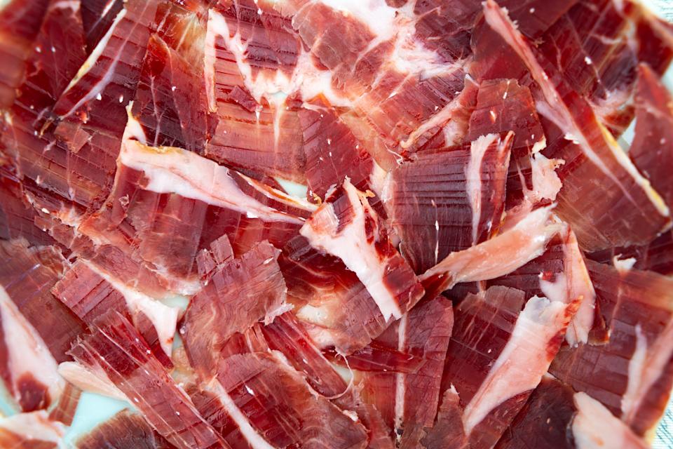 Premium iberian ham slices, a delectable spanish cured meat like prosciutto, on a platter