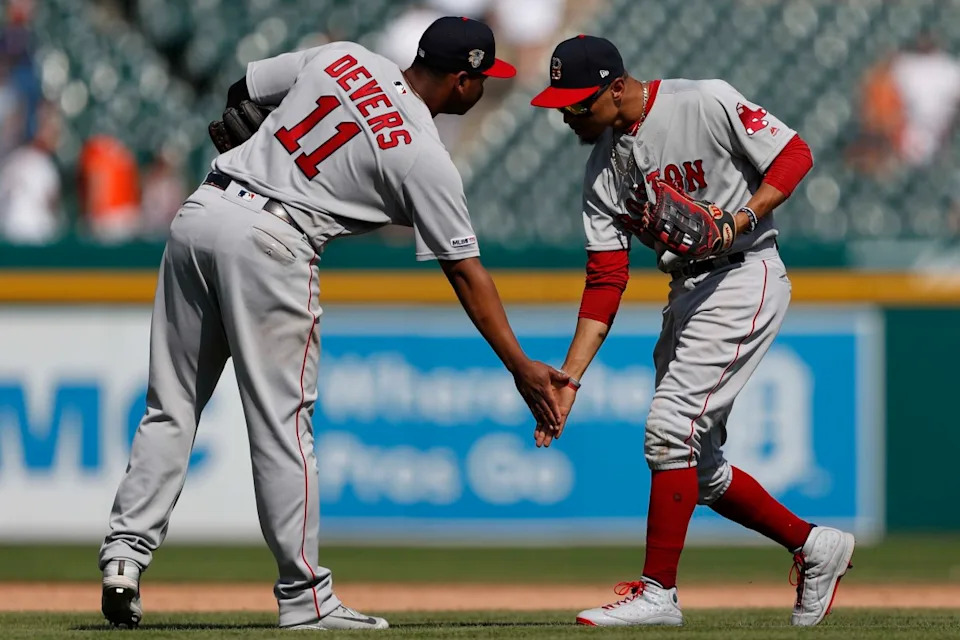 Jul 7, 2019; Detroit, MI, USA; Boston Red Sox right fielder Mookie Betts (50) celebrates with third baseman Rafael Devers (11) after the game against the Detroit Tigers at Comerica Park.Raj Mehta-Imagn Images
