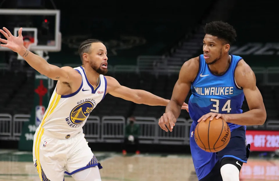 Dec 25, 2020; Milwaukee, WI, USA; Milwaukee Bucks forward Giannis Antetokounmpo (34) dribbles the ball against Golden State Warriors guard Stephen Curry (30) during a NBA game at the Bradley Center.© Handout Photo-Imagn Images