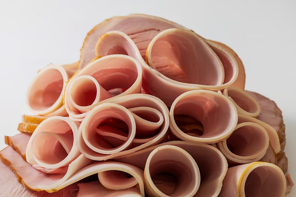 A photo of a pile of thin, curled slices of meat
