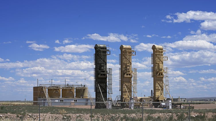 Large industrial equipment stands in an open space.