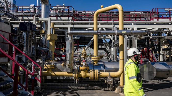 Workers at a natural gas production facility