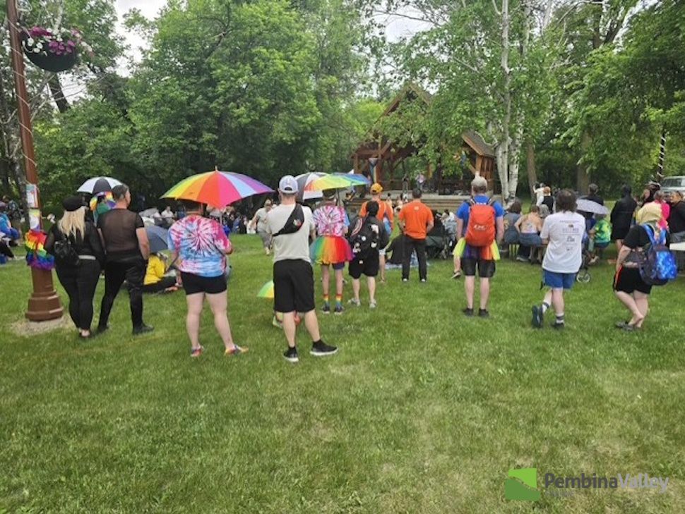people gather wearing rainbow clothing