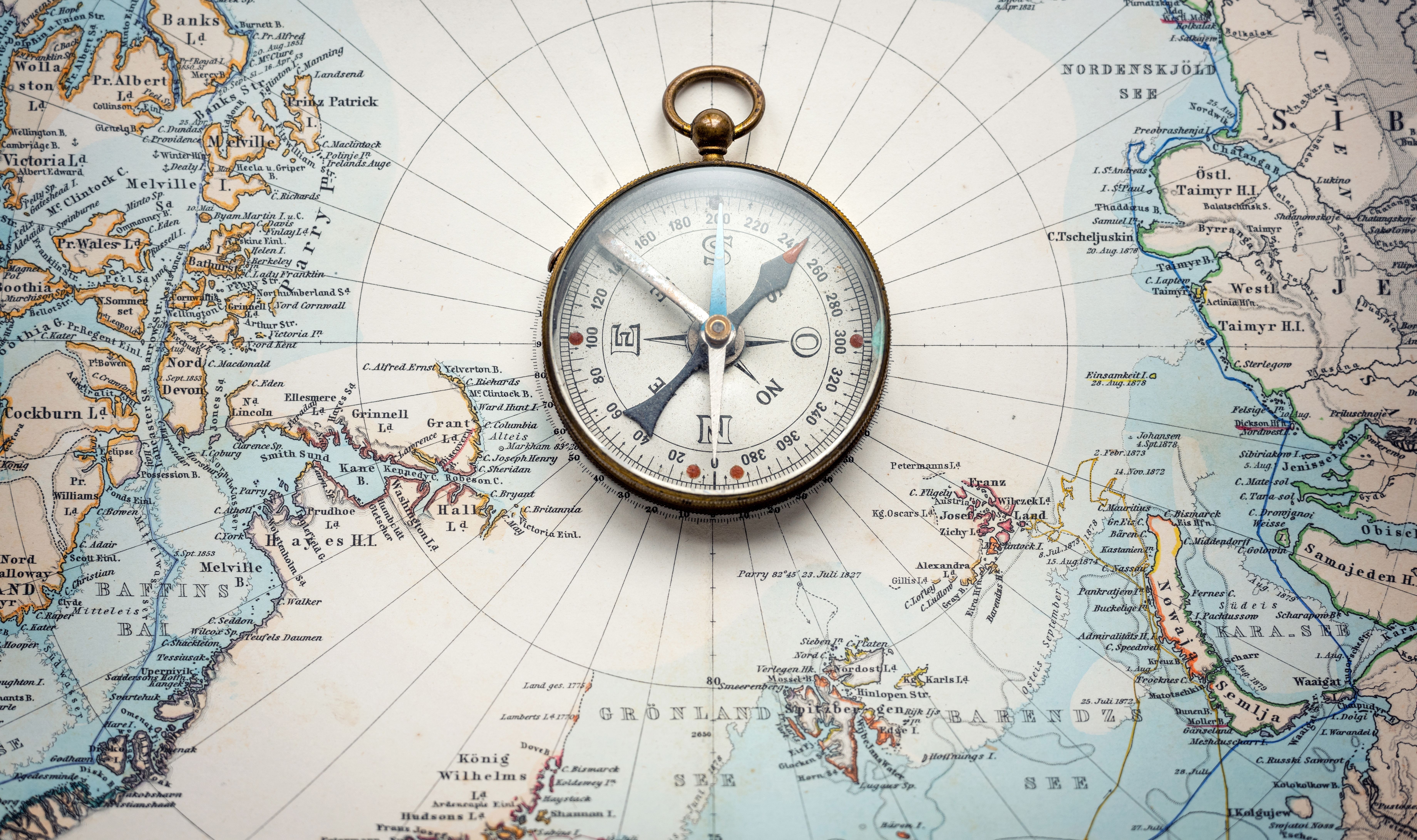 Compass sitting on an old map