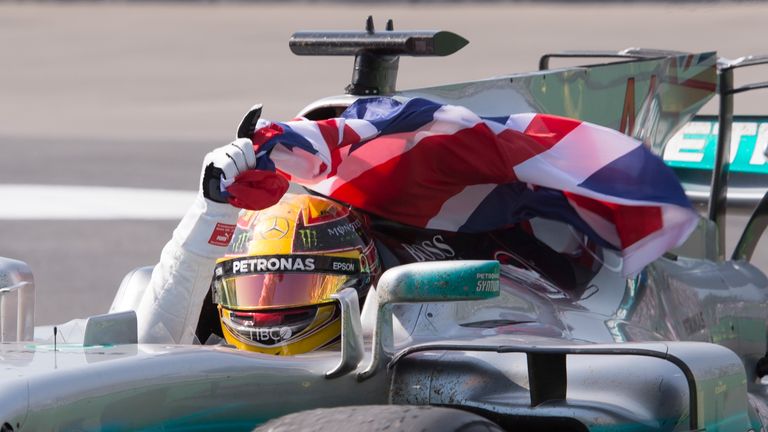 Mercedes driver Lewis Hamilton (44), of Britain, waves a flag after winning the Canadian Grand Prix auto race Sunday, June 11, 2017, in Montreal.