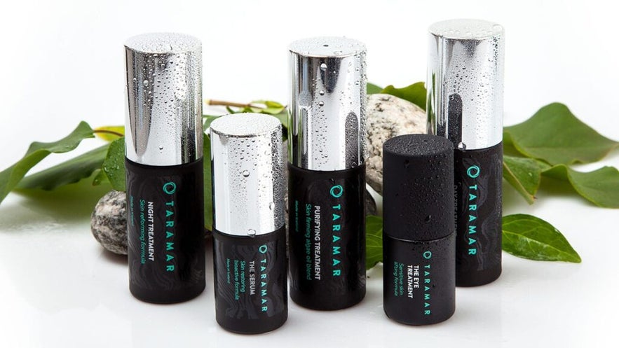 A set of wet Taramar skincare bottles, including Night Treatment, Serum, Purifying Treatment, and Eye Treatment.