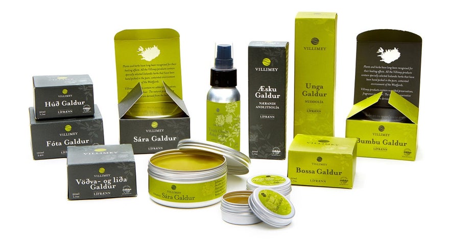A collection of Villimey organic skincare products in green and grey packaging, including creams, salves, and sprays.