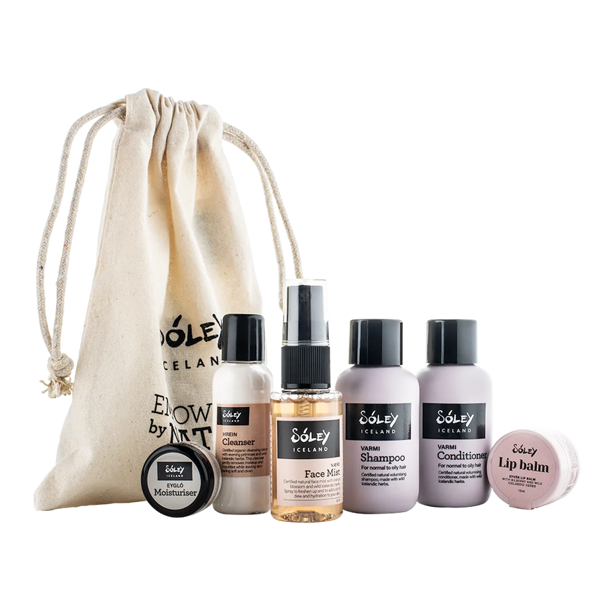 Sóley Organics Iceland travel essentials set with a drawstring bag, cleanser, mist, shampoo, conditioner, and balm.