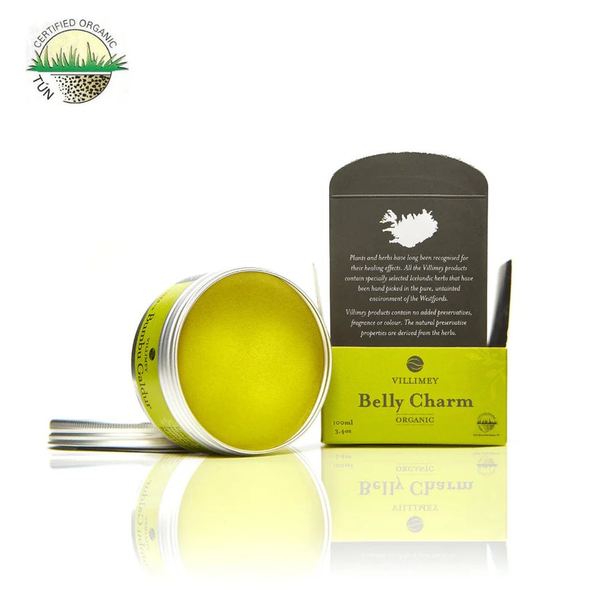 Villimey Belly Charm is open, showcasing its yellow-green balm along with its box and organic certification.