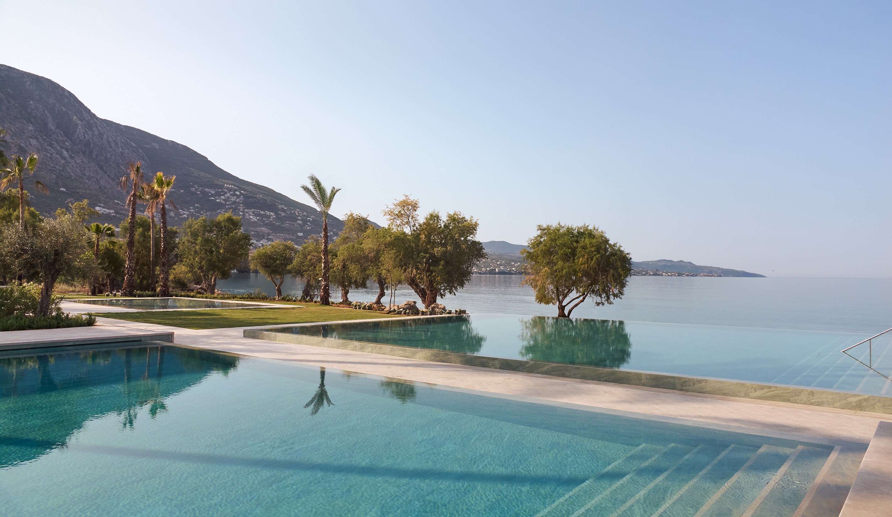 Infinity pool overlooking the sea and mountains.