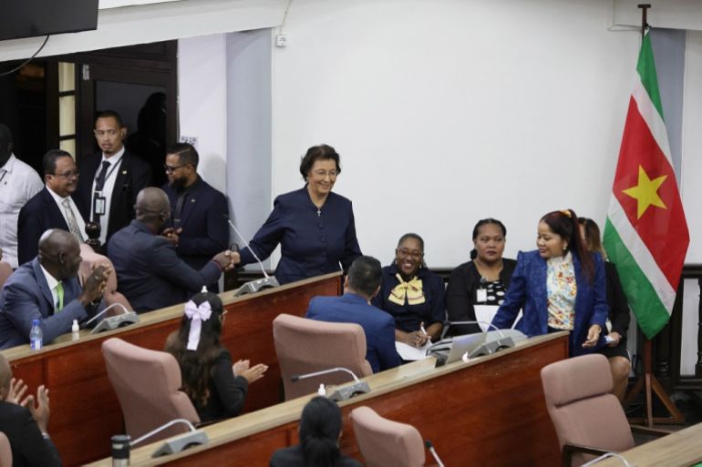Suriname's opposition leader Jennifer Geerlings-Simons (C) greets parliamentarians after the National Assembly election in Paramaribo on July 6, 2025. [Ranu Abhelakh/ AFP]