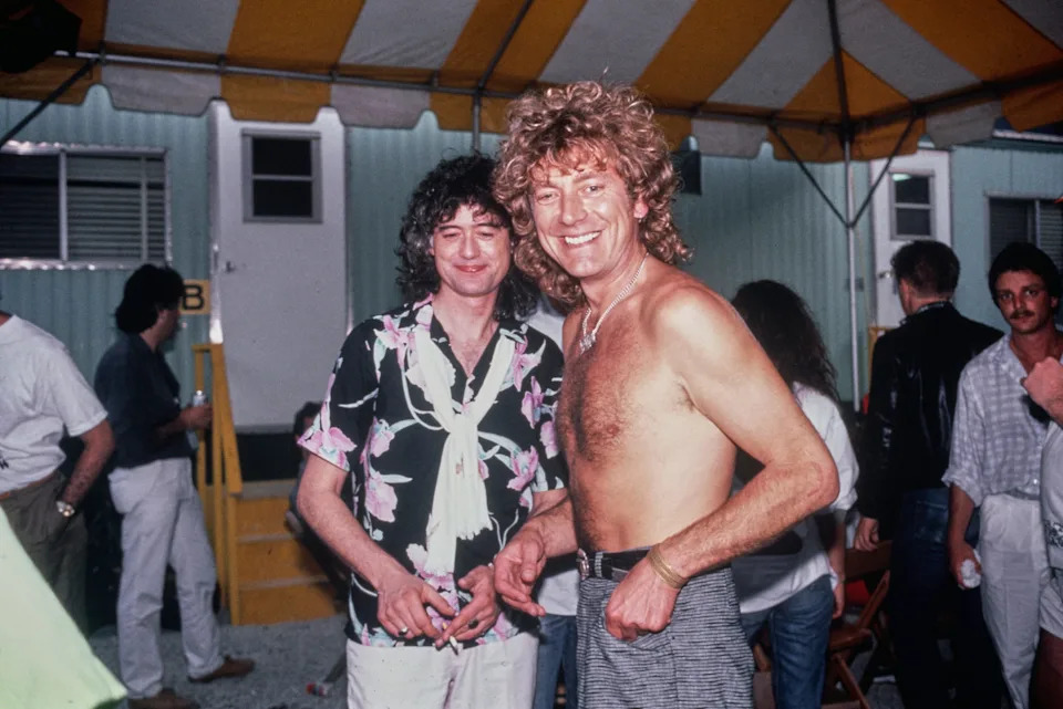 British musicians Jimmy Page (left) and Robert Plant pictured backstage at Live Aid in Philadelphia after performing with a re-formed Led Zeppelin.