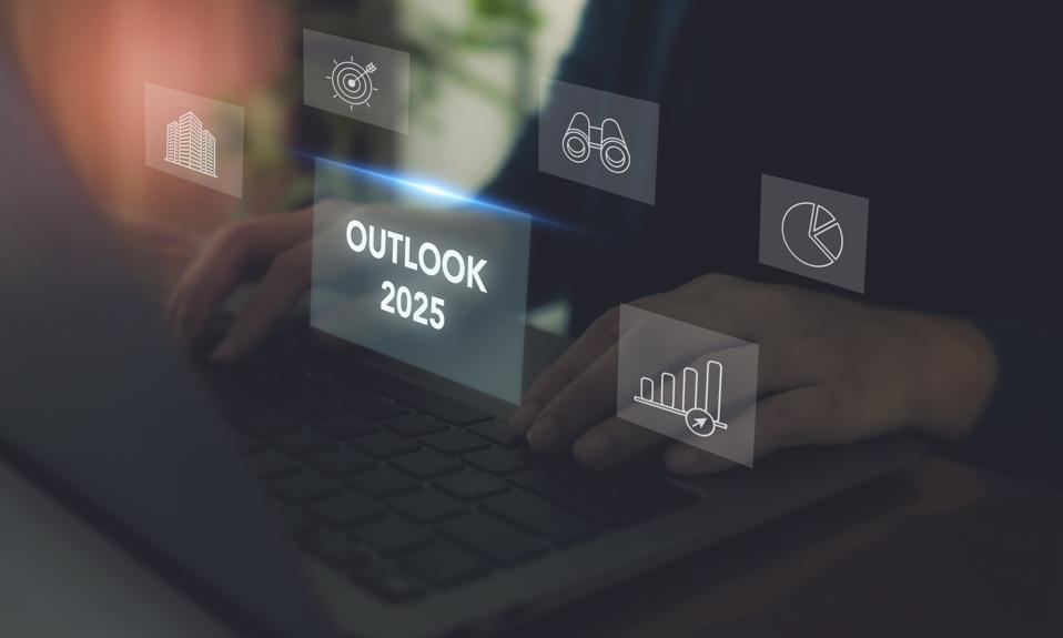 Economic, business outlook concept. Financial, business view or economic growth forecast for 2025. Businessman working on laptop with OUTLOOK 2025 text and business trend icons on virtual screen.