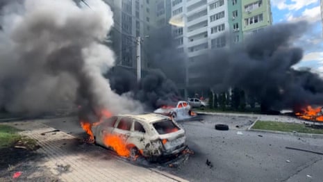 Shocked Ukrainians leave apartment block after Russian bomb hits Kharkiv – video