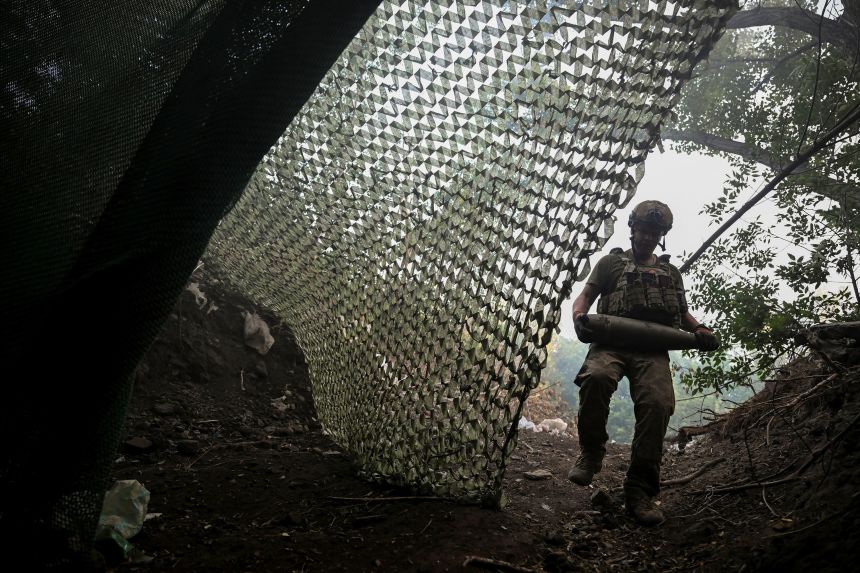 A Ukrainian artilleryman carries a shell as he prepares to fire a self-propelled howitzer towards Russian troops near the city of Kostiantynivka, in Ukraine's Donetsk region, on July 5.