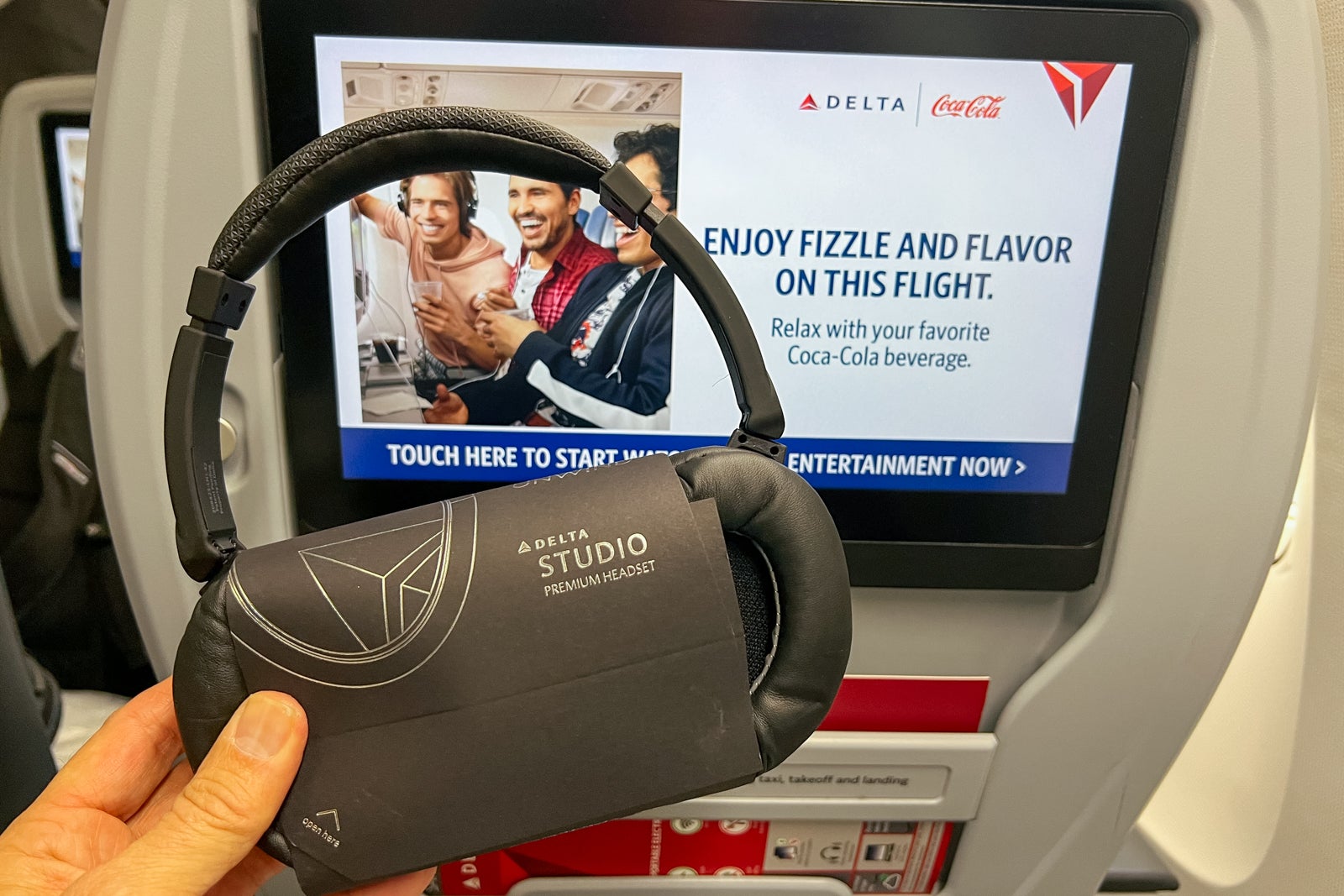 In flight entertainment screen with headphones. 