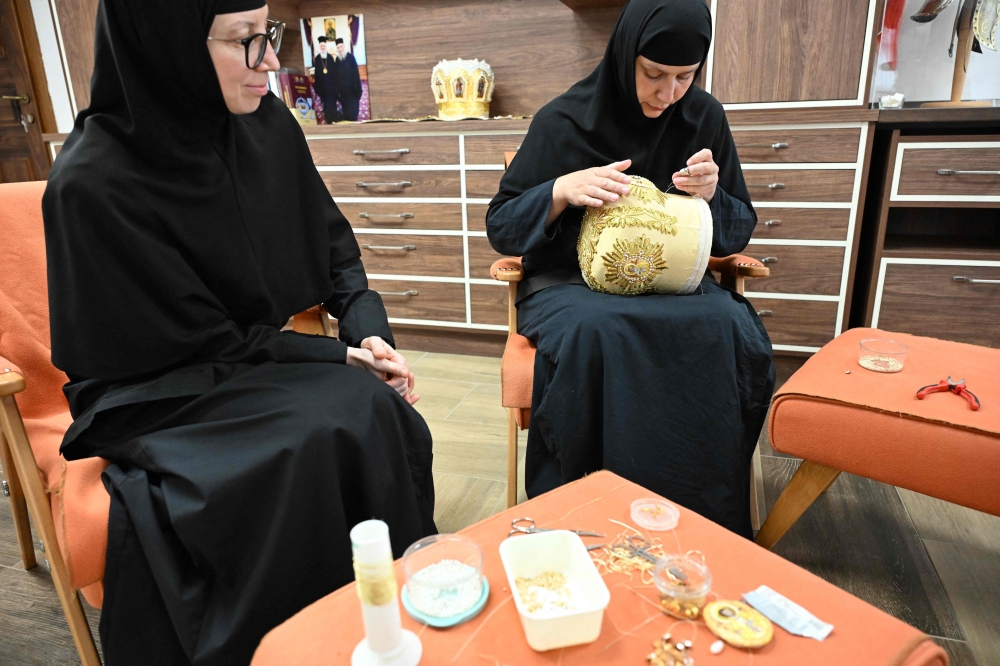Christian Orthodox nuns Efimija (L) and Elisaveta (R) work on a mitre, a liturgical vestment, in the monastery of Saint George the Victorious situated in the village of Rajcica, some 132 kilometers west of capital Skopje, North Macedonia. — AFP pic