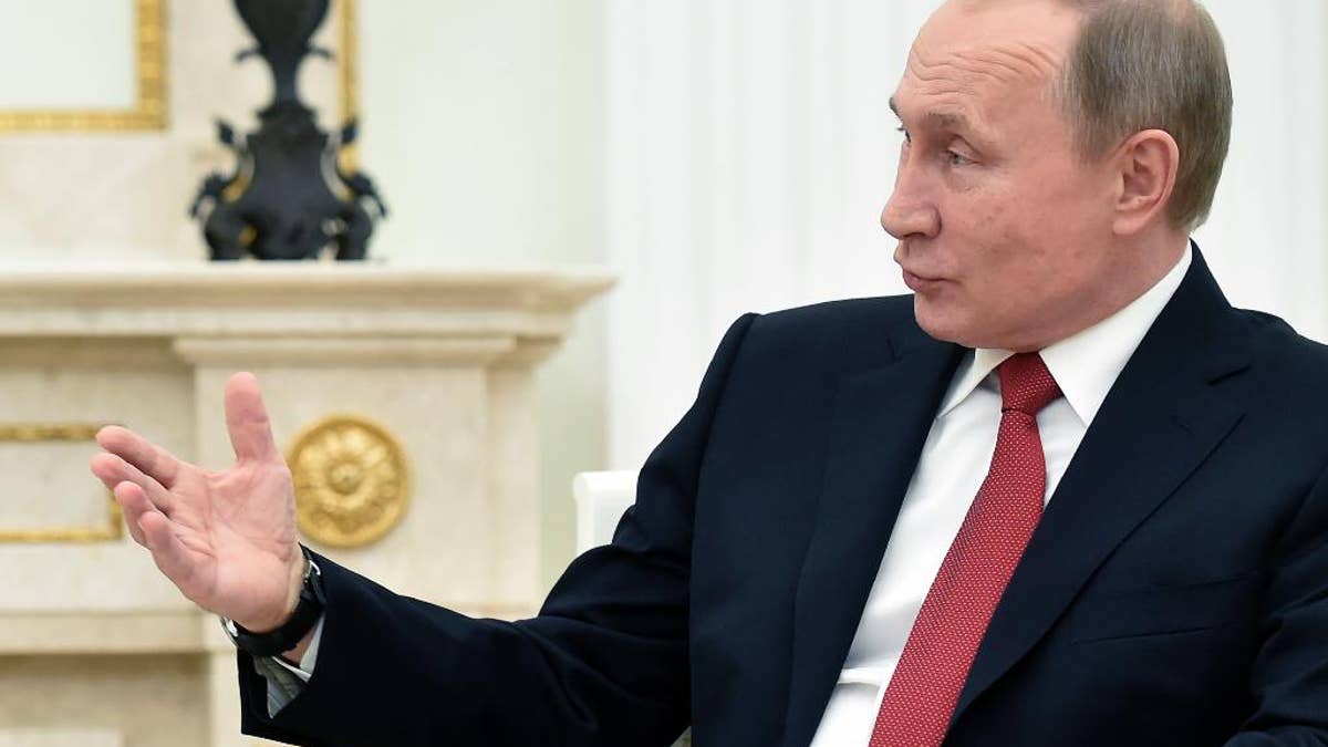 Russian President Vladimir Putin, gestures, as he meets leader of Georgia's breakaway province of Abkhazia Raul Khadzhimba in the Kremlin in Moscow, Russia on Thursday, Dec. 1, 2016. (Natalia Kolesnikova/Pool photo via AP)