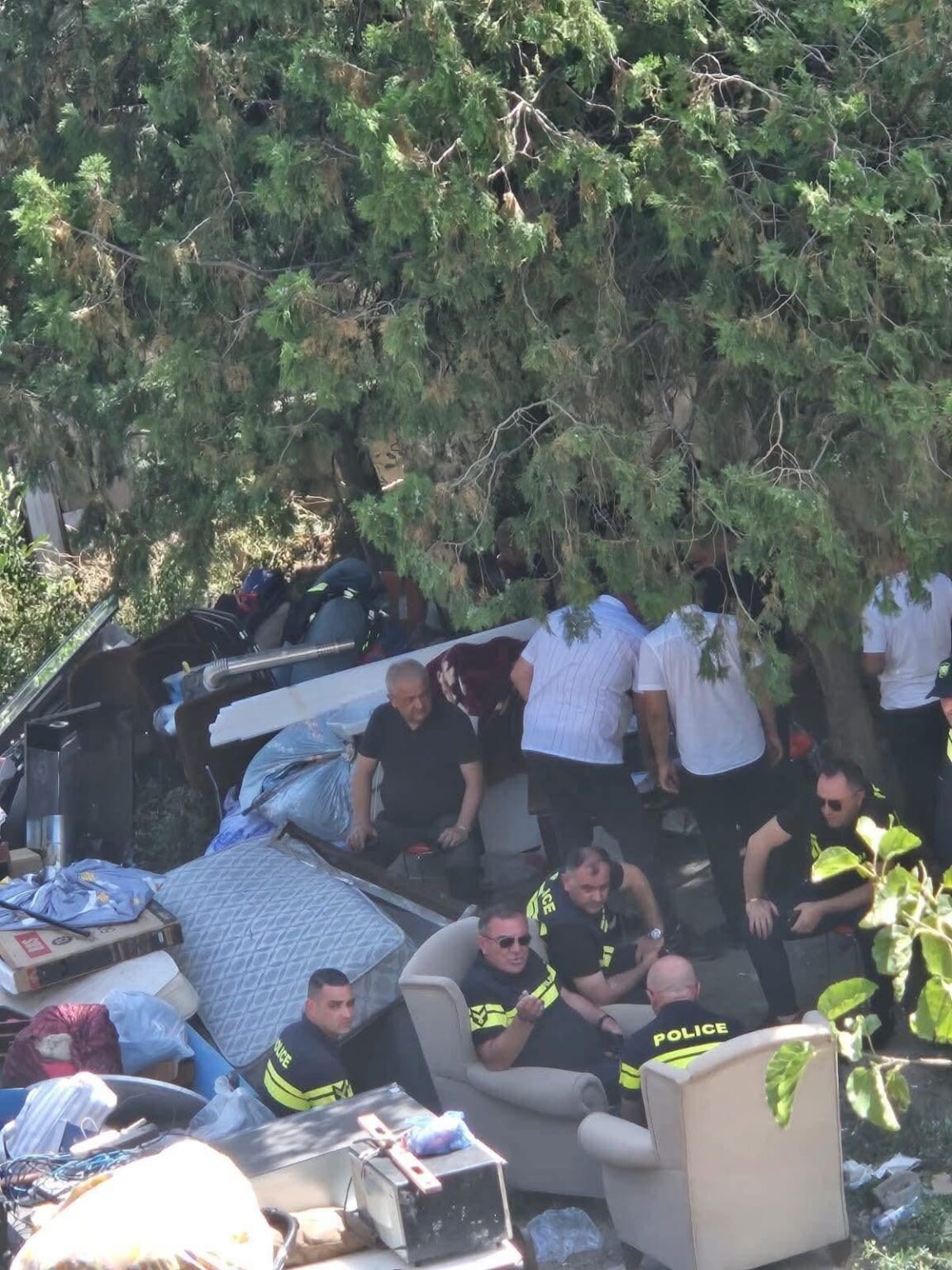 Police lounging on the furniture of displaced people they had just thrown out and left homeless as the building was dismantled - Tbilisi, 25.07.2025