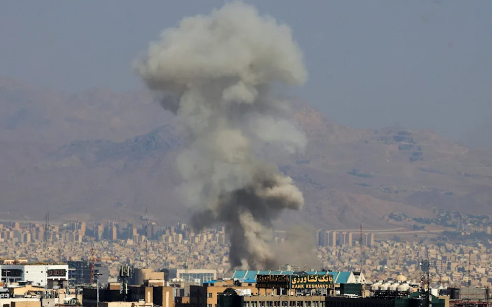 Smoke rises after a strike in Tehran in June
