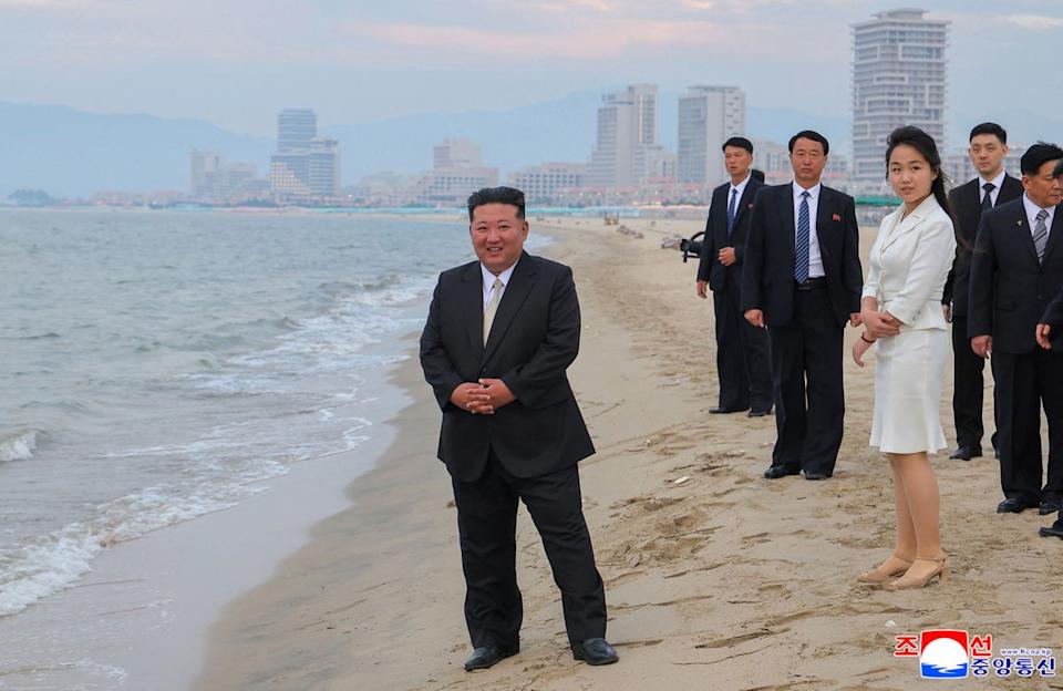 Kim Jong Un and his daughter on the beach at the resort (KCNA VIA KNS/AFP via Getty)