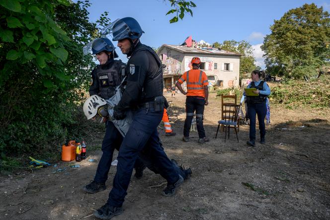 Police carry away an environmental activist during an operation to clear a protest against the proposed A69 national highway in Verfeil, France, September 18, 2024.
