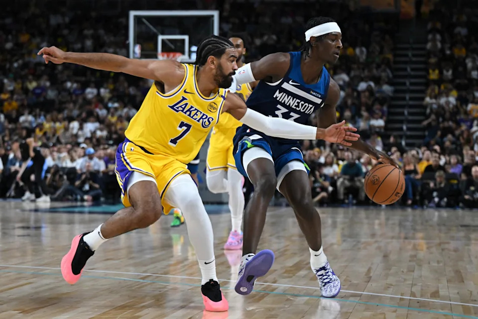 Oct 4, 2024; Palm Desert, California, USA; Los Angeles Lakers guard Gabe Vincent (7) passes against Minnesota Timberwolves forward Leonard Miller (33) during the second half at Acrisure Arena. Mandatory Credit: Jonathan Hui-Imagn Images