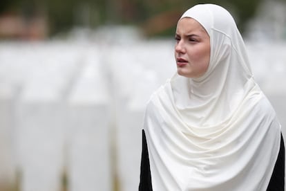 A Bosnian woman searches for a family member's gravestone at the Srebrenica-Potocari Memorial Center in Bosnia and Herzegovina on Thursday.