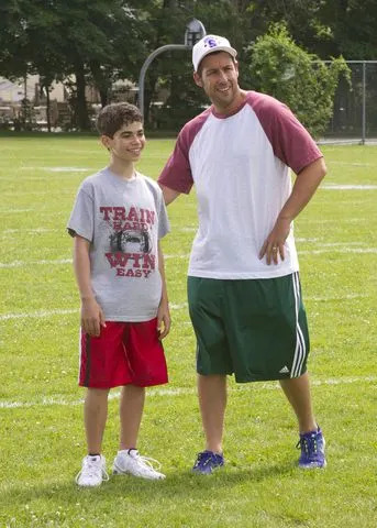 Columbia/Kobal/Shutterstock Cameron Boyce as Keithie with costar Adam Sandler in 'Grown Ups 2' in 2013