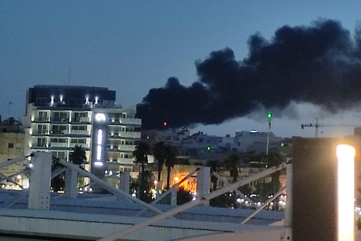 A thick black plume of smoke could be seen from a distance as a fire raged in two factories in Ħal Far.