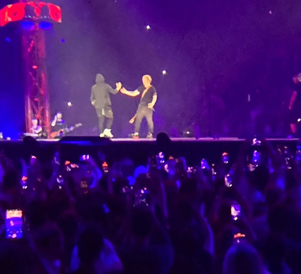 Ed Sheeran greets Eminem onstage during a concert at Ford Field on Saturday, July 15, 2023.