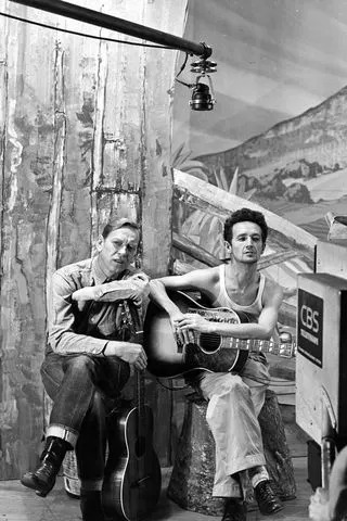 CBS via Getty Tony Kraber (left) and Woody Guthrie in 1945