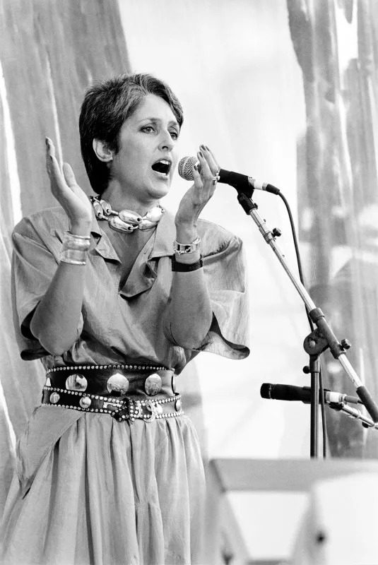 Joan Baez performing at Live Aid at JFK Stadium in Philadelphia, Pennsylvania on July 13, 1985. <p><a href="https://www.gettyimages.com/detail/2218203145" rel="nofollow noopener" target="_blank" data-ylk="slk:Ebet Roberts&sol;Getty Images;elm:context_link;itc:0;sec:content-canvas" class="link ">Ebet Roberts&sol;Getty Images</a></p>