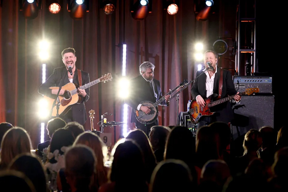 From left, Marcus Mumford, and Ted Dwane of Mumford & Sons perform at the American Museum of Natural History on Nov. 30, 2023, in New York.