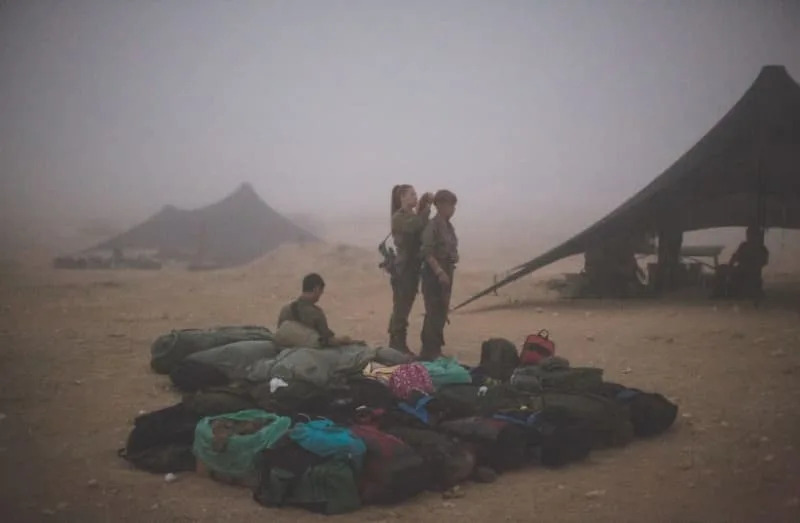 Female IDF soldiers in the field are seen dealing with extreme weather conditions. (credit: FLASH90)
