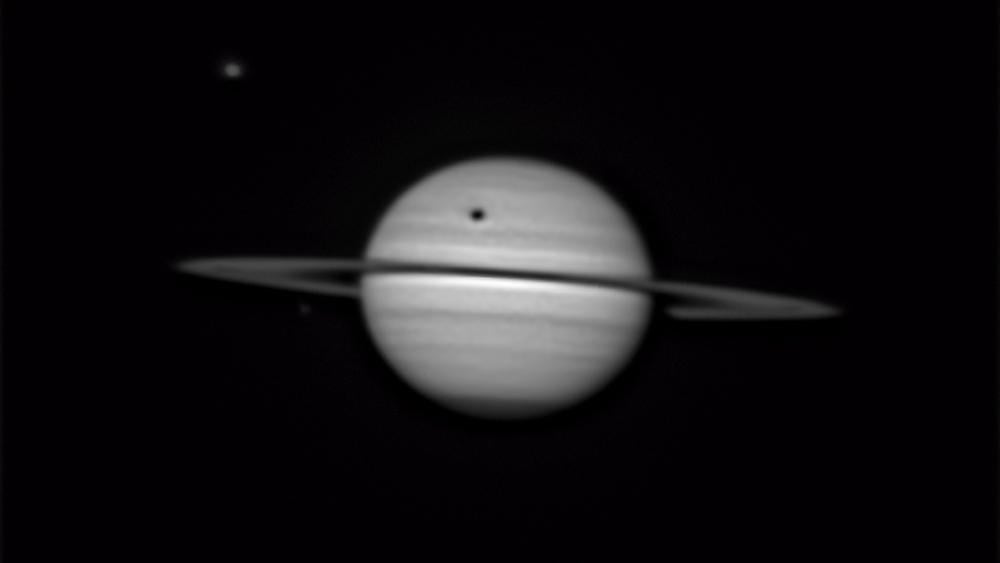 Saturn's largest moon Titan casts a colossal shadow in breathtaking amateur portrait