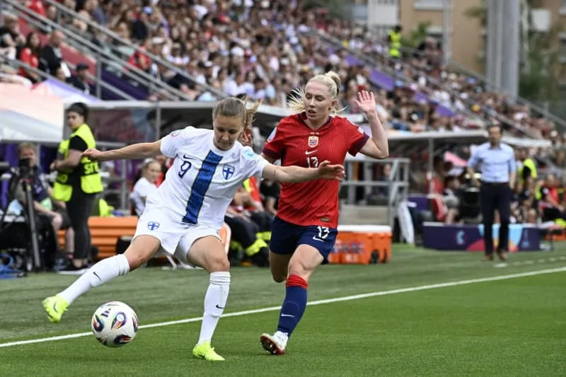Finland's Katariina Kosola (L) and Norway's Thea Bjelde battle for the ball during the UEFA Women's EURO 2025 Group A soccer match between Norway and Finland at Stade Tourbillon. Emmi Korhonen/Lehtikuva/dpa