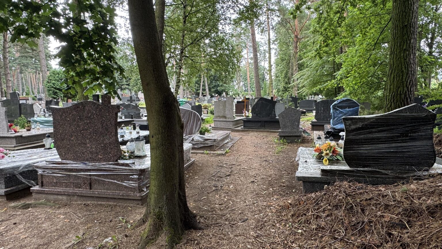 Tombstones and graves wrapped in plastic??