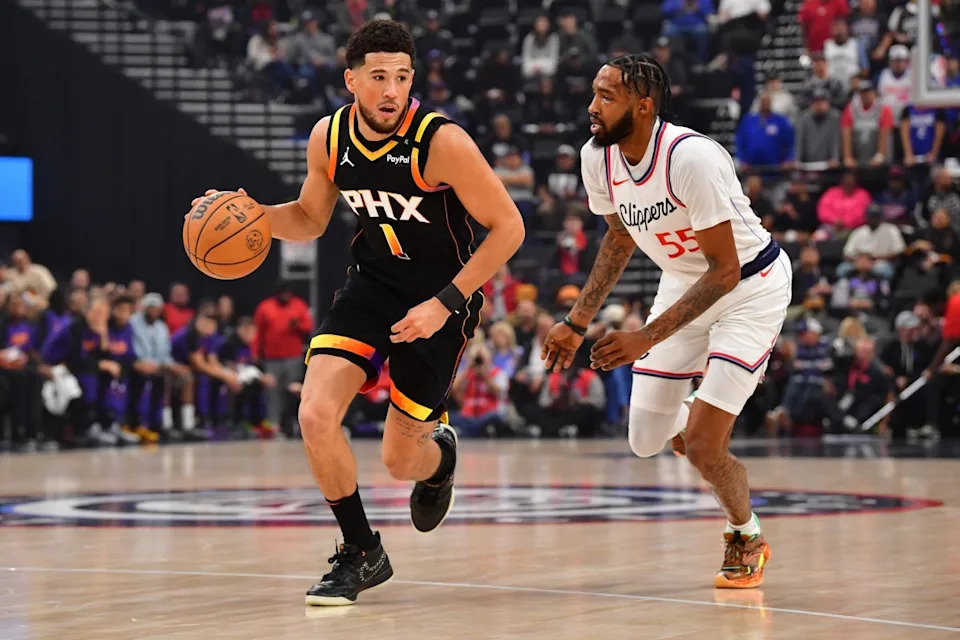 Phoenix Suns guard Devin Booker pushes the ball upcourt as Los Angeles Clippers forward Derrick Jones Jr. defends at Intuit Dome on Oct. 31, 2024.Gary A&period; Vasquez-Imagn Images